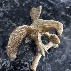 vintage brass bald eagle figurine perched on a Branch